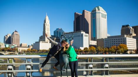 Posing with the deer sculpture in front of the city skyline on the Scioto Mile