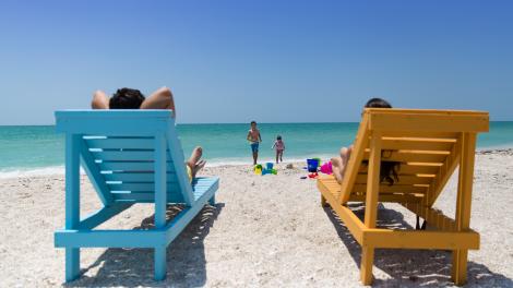 Relaxing in colorful sun loungers on the beach