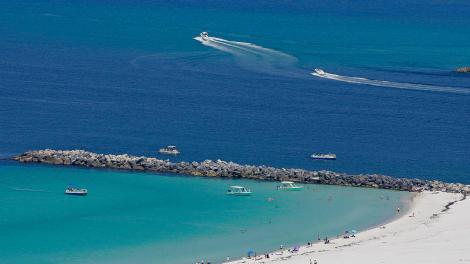 Aerial view of white-sand beaches and turquoise waters at Shell Island Pass in Panama City Beach, Florida