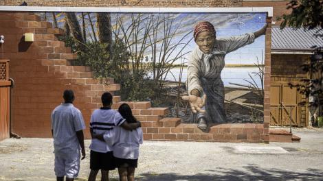 Family viewing a mural featuring Harriet Tubman by Michael Rosato in Dorchester County, Maryland Family viewing a mural featuring Harriet Tubman by Michael Rosato in Dorchester County, Maryland