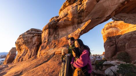 A family sharing an incredible view at Arches National Park in Utah