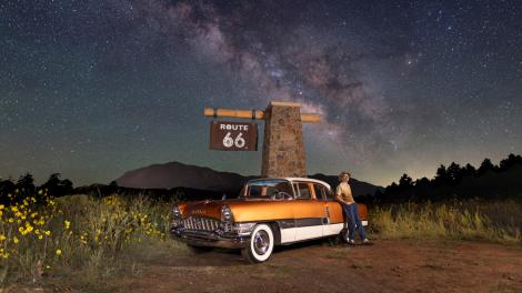 Posing with a classic car and Route 66 sign on a starry night in Flagstaff, Arizona