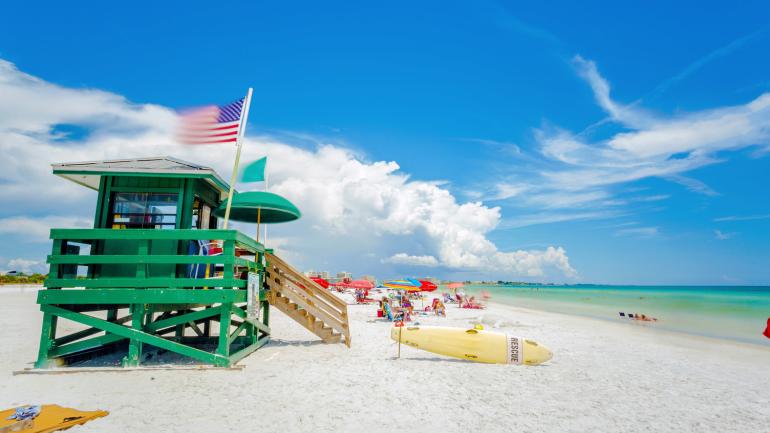 A colorful lifeguard stand on the white sands of Siesta Key Beach