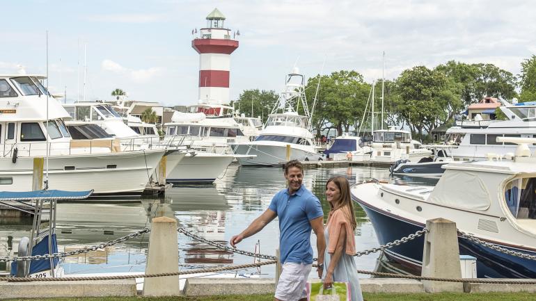 Couple exploring the waterfront near the Harbour Town Lighthouse in Hilton Head Island