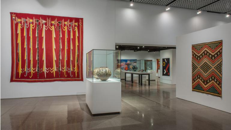 Displays of colorful textiles and pottery inside the historic Heard Museum