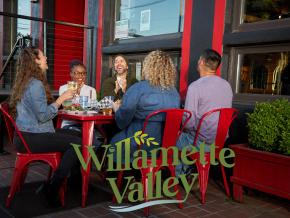 Glasses raised in a toast at Hop Valley Brewing in Eugene, Oregon