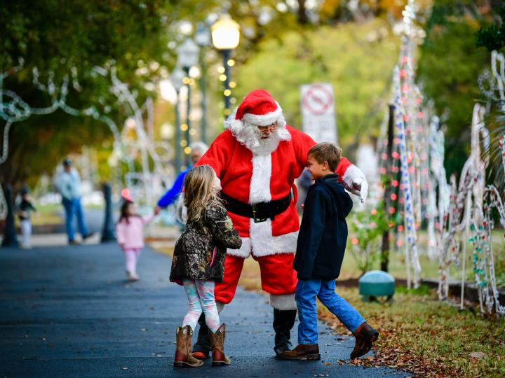 A Santa Claus impersonator greeting children at 50 Nights of Lights in Cleveland, Mississippi