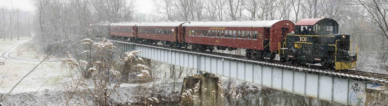 The Walkersville Southern Railroad traverses a snowy landscape in Walkersville, Maryland