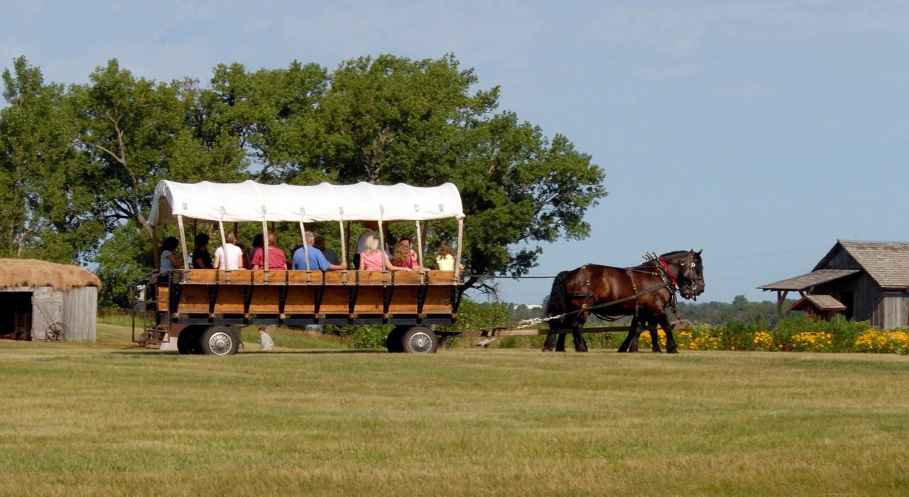 Riding in a covered wagon at the Laura Ingalls Wilder Homestead in De Smet