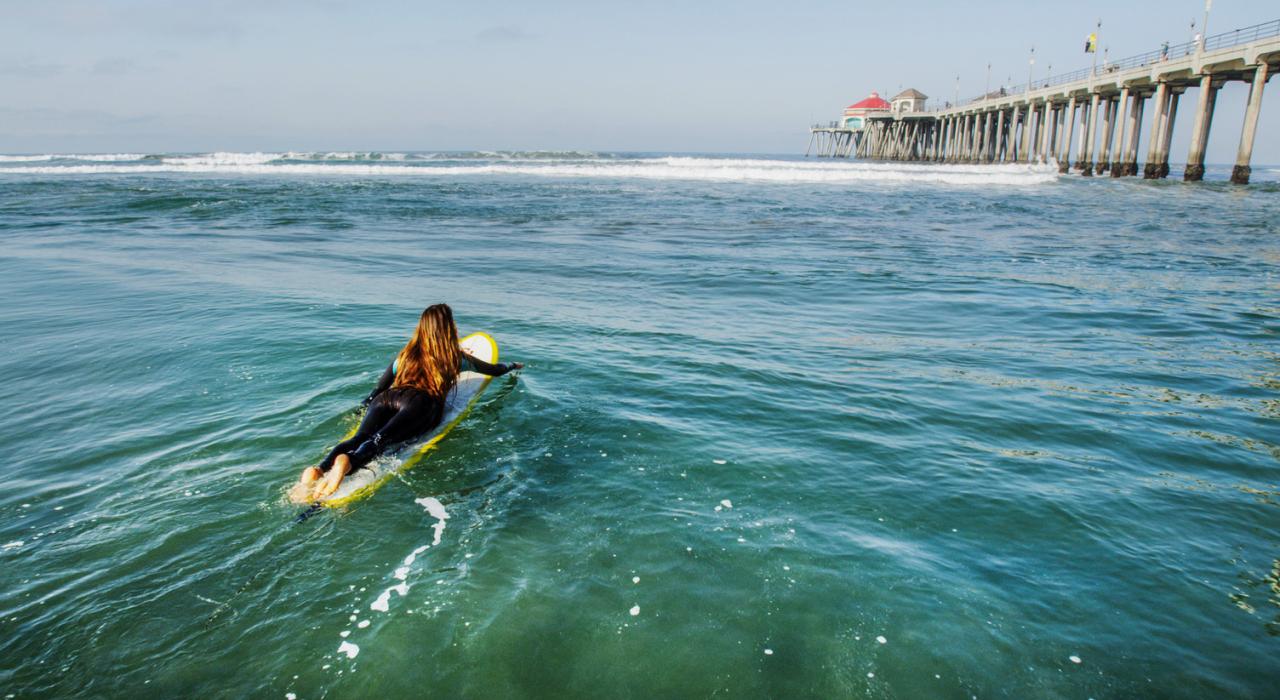 Paddling out to surf in the city that made it famous