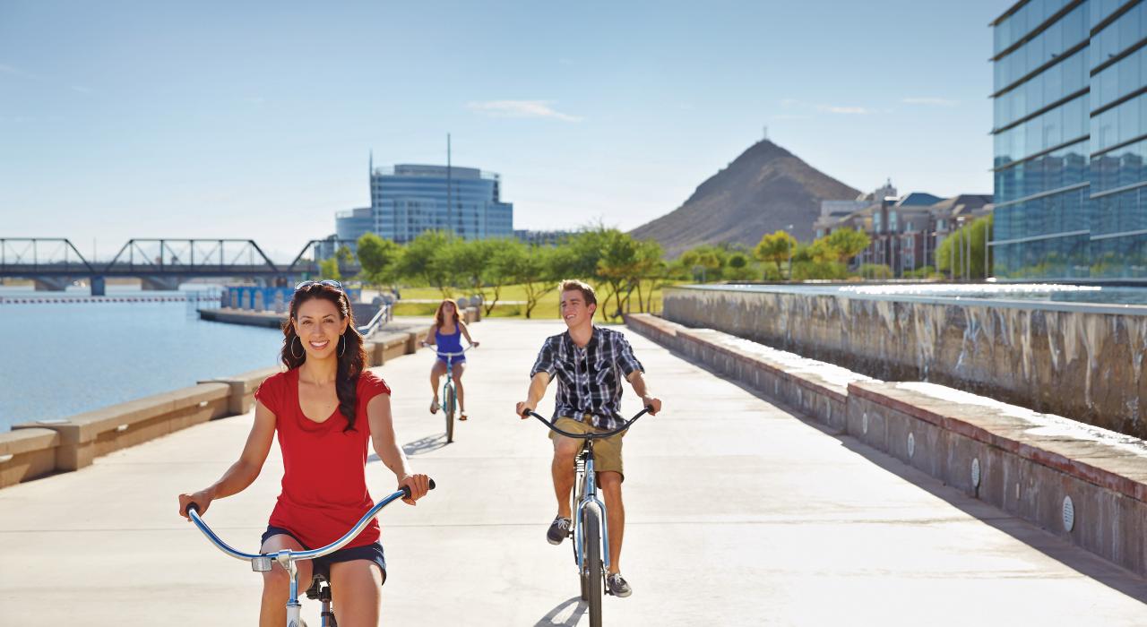 Riding bikes alongside Tempe Town Lake and Tempe Center for the Arts