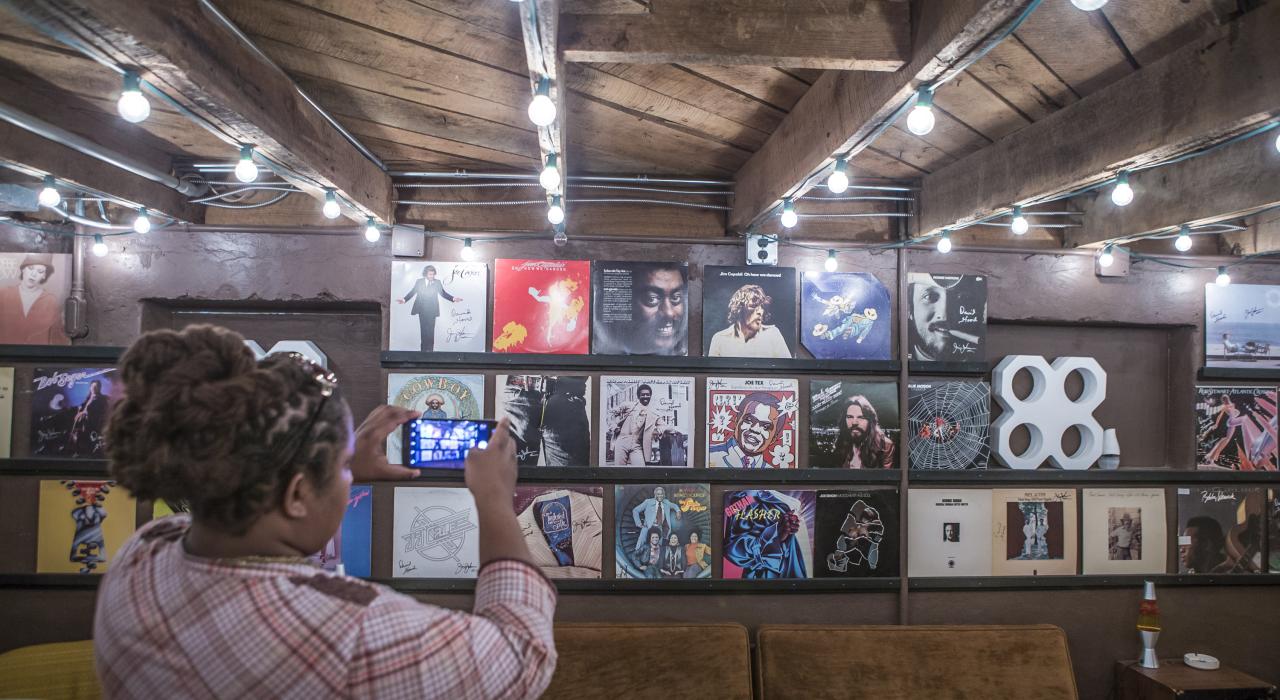 Viewing record album covers inside Muscle Shoals Sound Studio